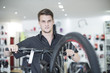 © Westend61 - Young man working in bicycle shop