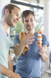 © Westend61 - Happy gay couple preparing meat skewers in kitchen