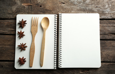 Open recipe book on wooden background