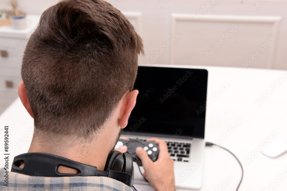Young man playing computer games at home Stock Photo | Adobe Stock