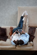 © alotofpeople - couple sitting on couch