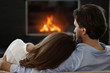 © alotofpeople - couple next to the fireplace