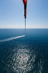 Wall Mural - Flight with a parachute over the sea