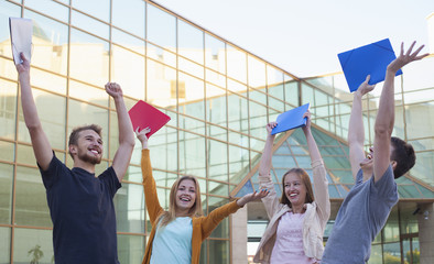 Group of cheerful student show education success raising hands up with folders