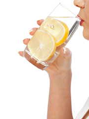 Wall Mural - Woman drinking water with lemon