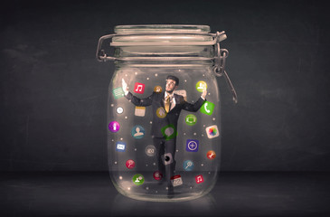 Canvas Print - Businessman captured in a glass jar with colourful app icons con