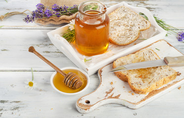 Jar of honey  and toasts for breakfast.