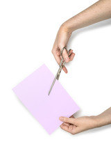 Hand cutting a sheet of paper with scissors