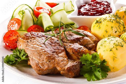 Fototapeta na wymiar Fried steak, boiled potatoes and vegetable salad 