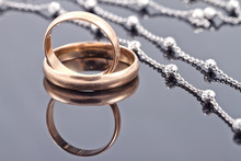 Golden Wedding Rings And Elegant Silver Chain