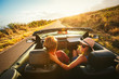 © EpicStockMedia - Happy Couple Driving in Convertible