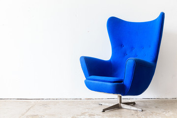 vintage armchair on white wall.