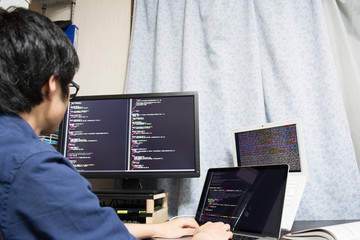 asian engineer writing a programme on a computer