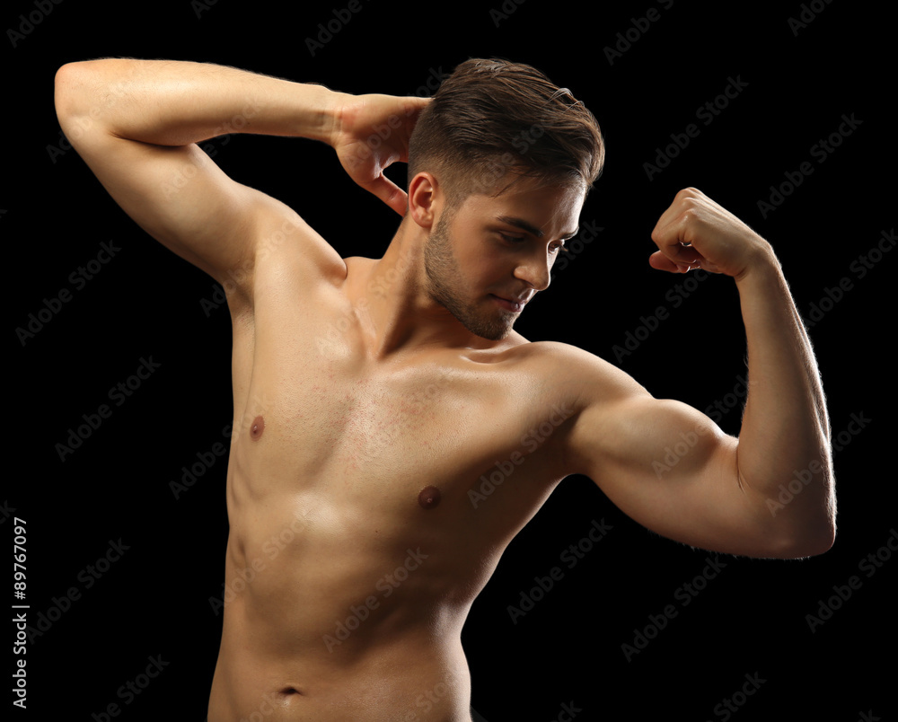 Muscle young man on dark background