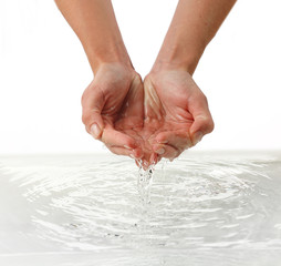 Wall Mural - Female hands over clear water background