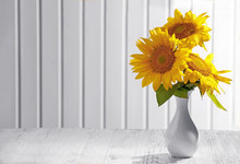 Beautiful Bright Sunflowers In Vase On Wooden Background