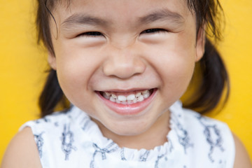 close up face of asian kid toothy smiling facial face with happi