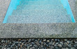 stone on the edge of the swimming pool