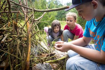 Boy kindles bonfire in forest