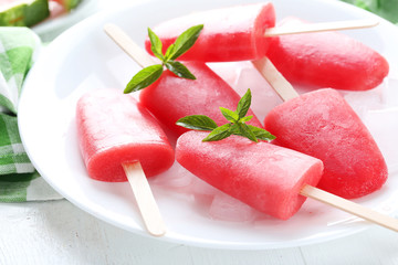 Poster - Watermelon popsicle on plate on white wooden table