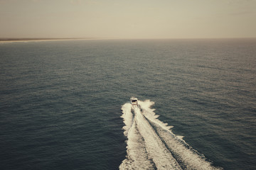 Wall Mural - Motor boat sailing towards the horizon