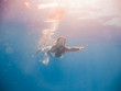 © Netfalls - Young woman swimming undewater
