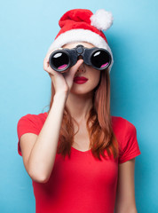 women in christmas hat with binocular