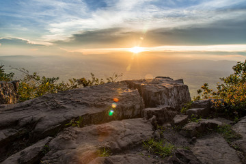 Wall Mural - sunset at mountain lake with flare from sun