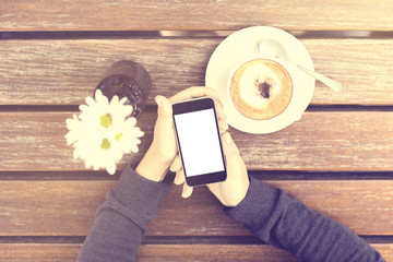 Wall Mural - Girl with blank cell phone and cup of coffee