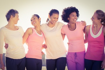 Laughing women wearing pink for breast cancer