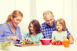 © Syda Productions - happy family with two kids making dinner at home