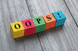 word oops on colorful wooden cubes