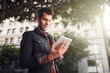 © Joshua Resnick - handsome man in down town los angeles using tablet on the go