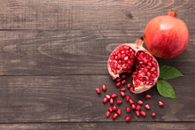 Ripe Pomegranate Fruit On Wooden Vintage Background