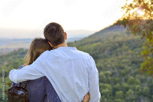 Fotografie, Obraz Loving couple hugging outdoors with the look at the sunset. Roma