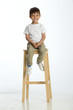 © dglimages - Little boy sitting on a high stool