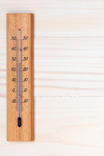 Thermometer On Wooden Background