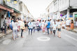 © surasaki - Blurred people walking on the street in phuket old town