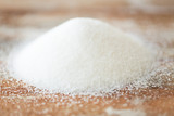Fototapeta  - close up of white sugar heap on wooden table