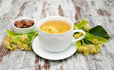 Wall Mural - cup of herbal tea with linden flowers