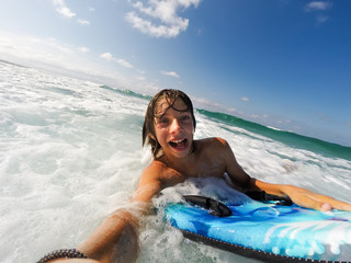  boy enjoys riding the waves with a surfboard