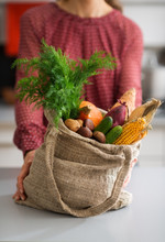 Closeup Of Burlap Sac Filled With Fall Vegetables With Woman