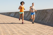 Two Young Women Jogging Together