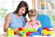 © Oksana Kuzmina - mother and kid play with toys at home