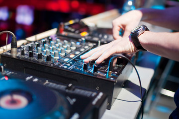 DJ mixing music on console