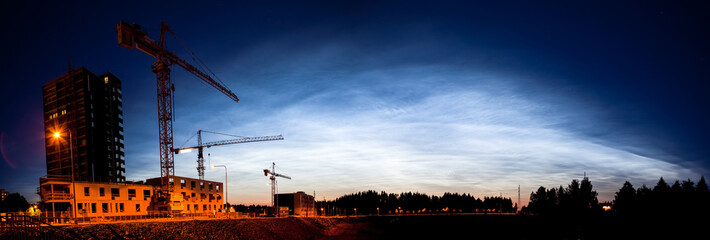 Wall Mural - noctilucent clouds glowing at night sky panorama