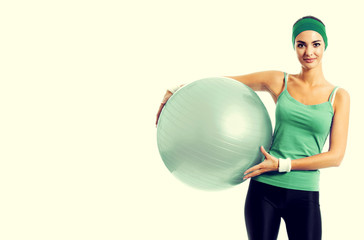 Cheerful smiling woman with fitball, with copyspace