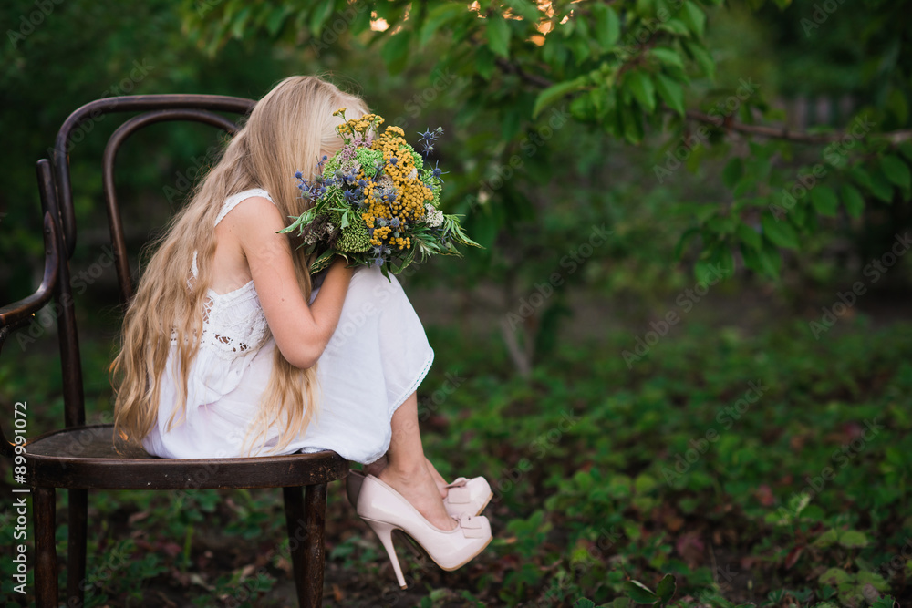 The little girl in high-heeled shoes large size in a white dress ...