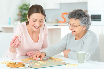 Elderly woman playing a board game