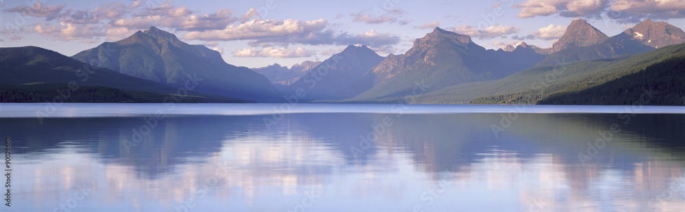 This is Lake McDonald. The surrounding mountains are reflected in the lake. - obrazy, fototapety, plakaty 